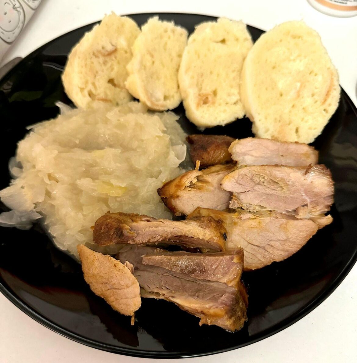 Grilled pork knuckle in marinade, dumpling and cabbage.