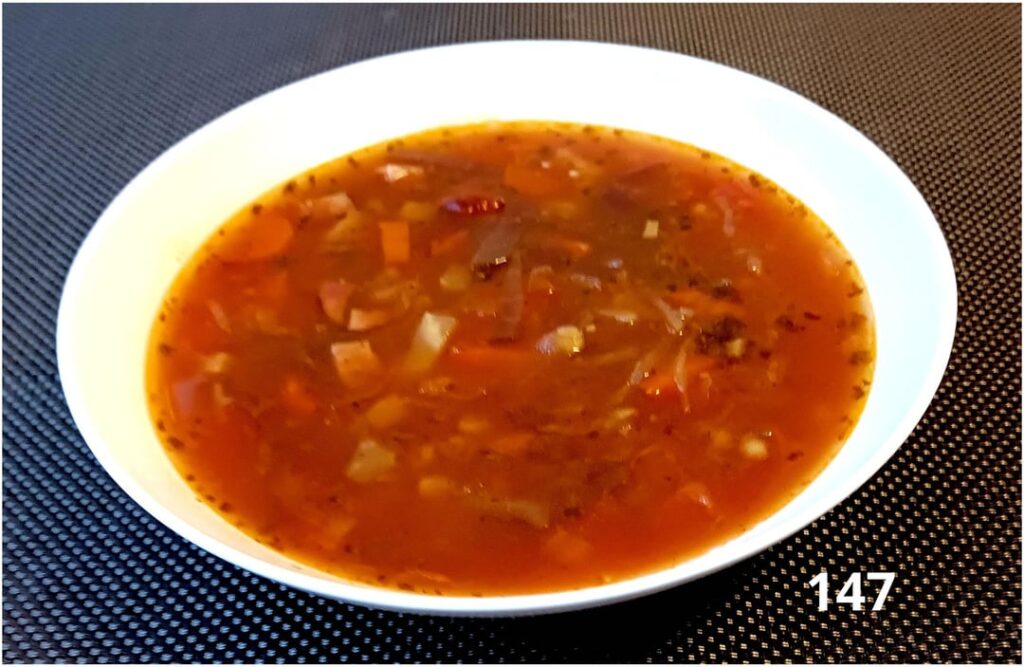 "Borshch" soup, potato dumpling skewers, sausages, cucumbers and bacon, pepper sauce and cucumber salad.