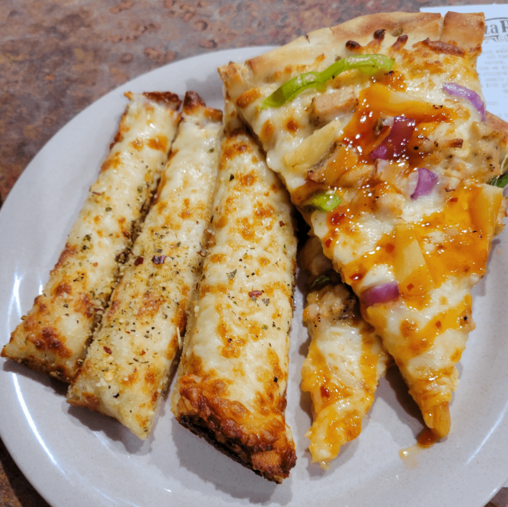 Cheese sticks accompanied by a sweet chili pizza from the pizza ranch.