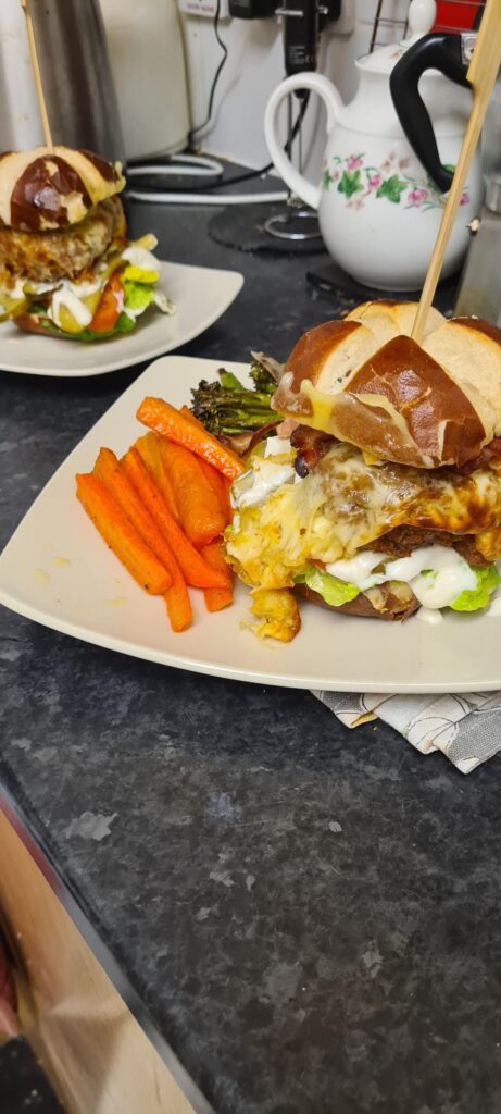 Mahoosive spicy chicken cheeseburger in a lidl pretzel bun. All the trimmings. And mayo.