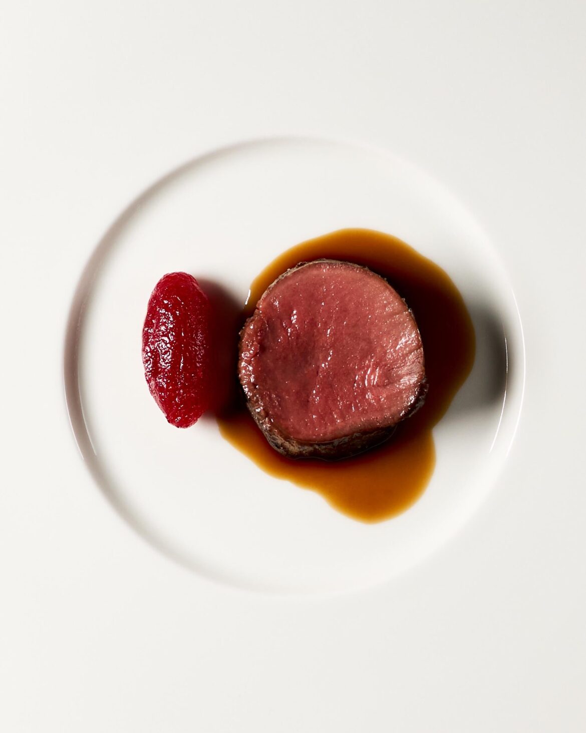 Deer with a sherry vinegar and lingonberry gelée, served with a sauce of demi-glace, sake, and gyokuro tea.