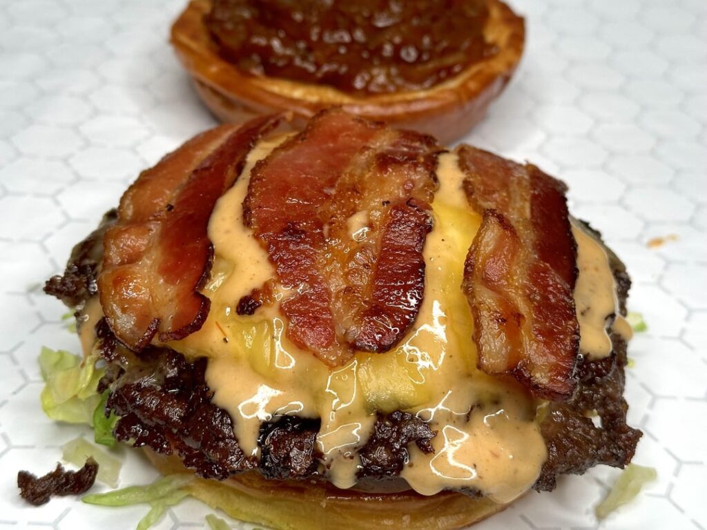 Homemade smash burger with BBQ onions and bacon