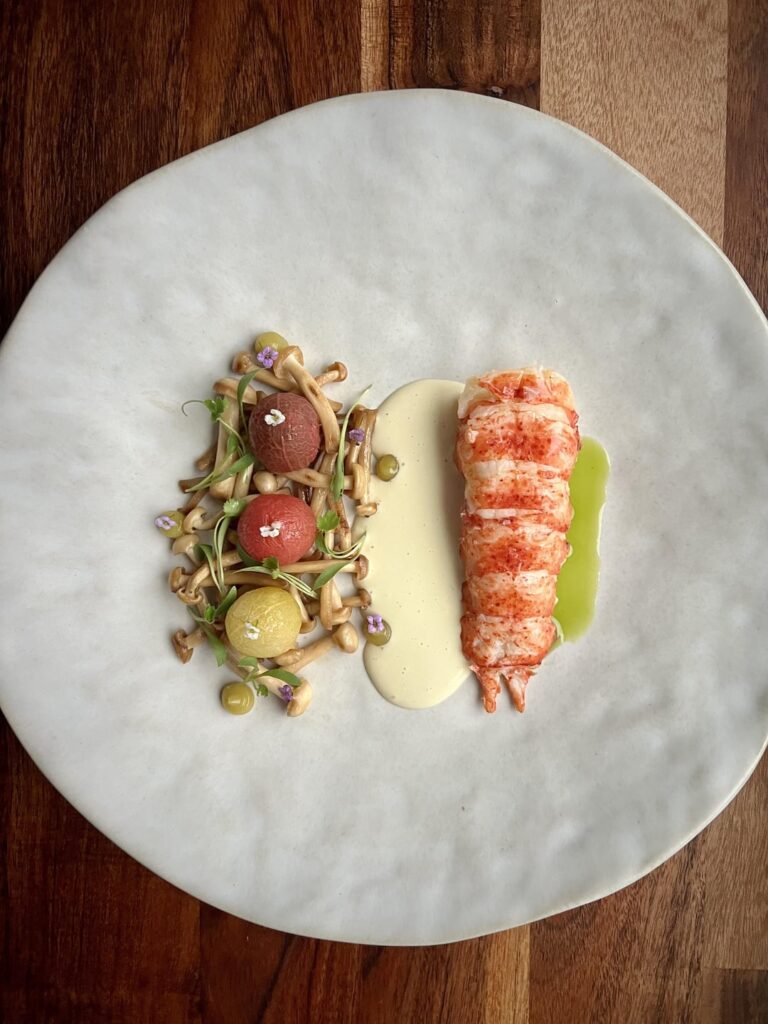 Butter Poached Lobster | Tom Kha Beurre Blanc | Chili Confit Tomatoes | Fish Sauce Beech Mushrooms | Makrut Lime Gel | Scallion & Cilantro Oil | Micro Cilantro | Alyssum Flowers