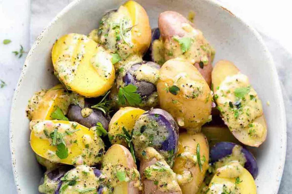 8 Cold Thanksgiving Side Dishes That Are Perfect for a Small Outdoor Gathering person with brown curly afro wearing blue cotton pajamas sitting cross-legged on their bed in the morning while drinking golden milk, learning how to stop feeling tired in winter