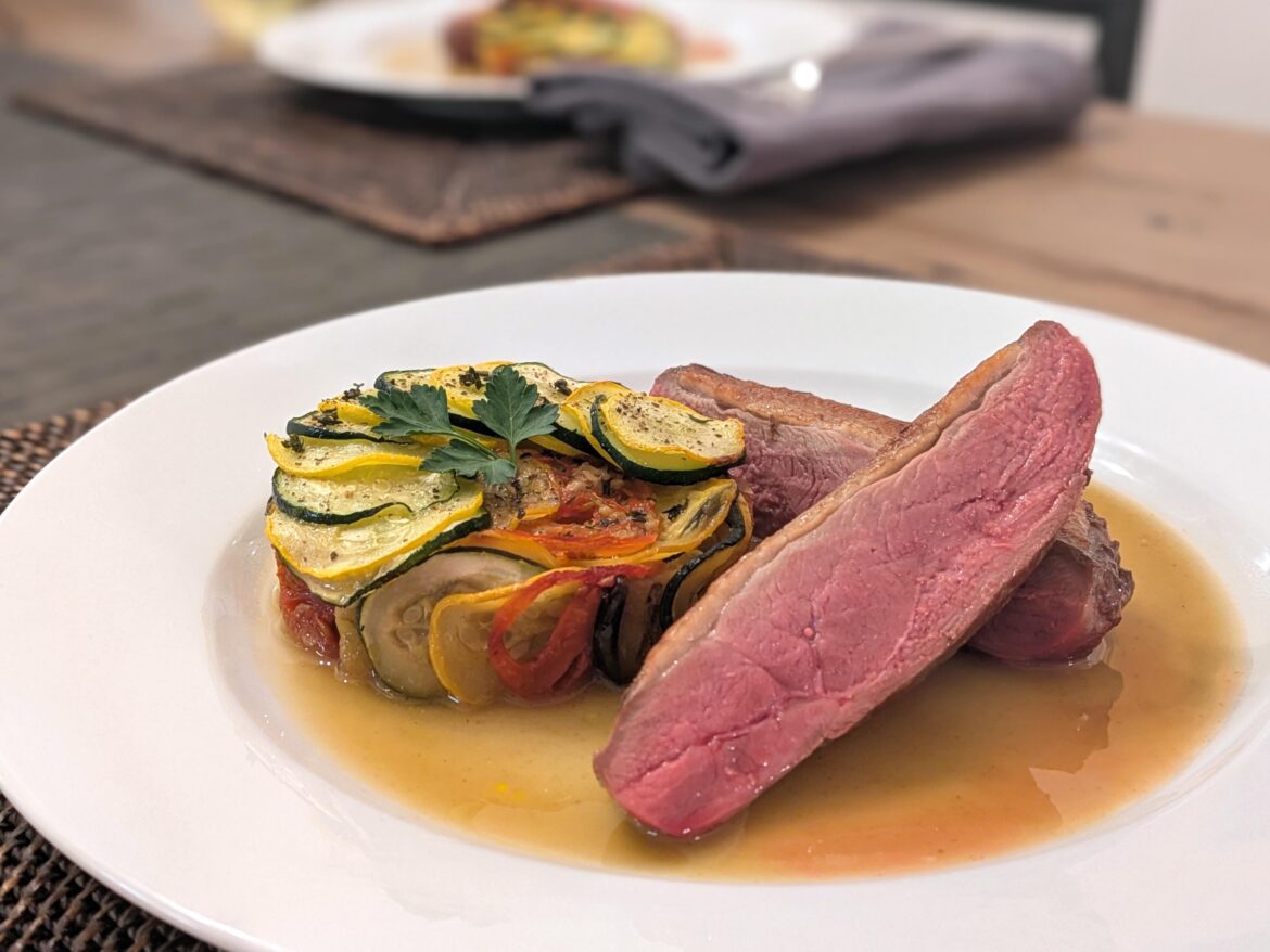 Seared duck breast, confit byaldi, duck jus, and obscenely large parsley leaf