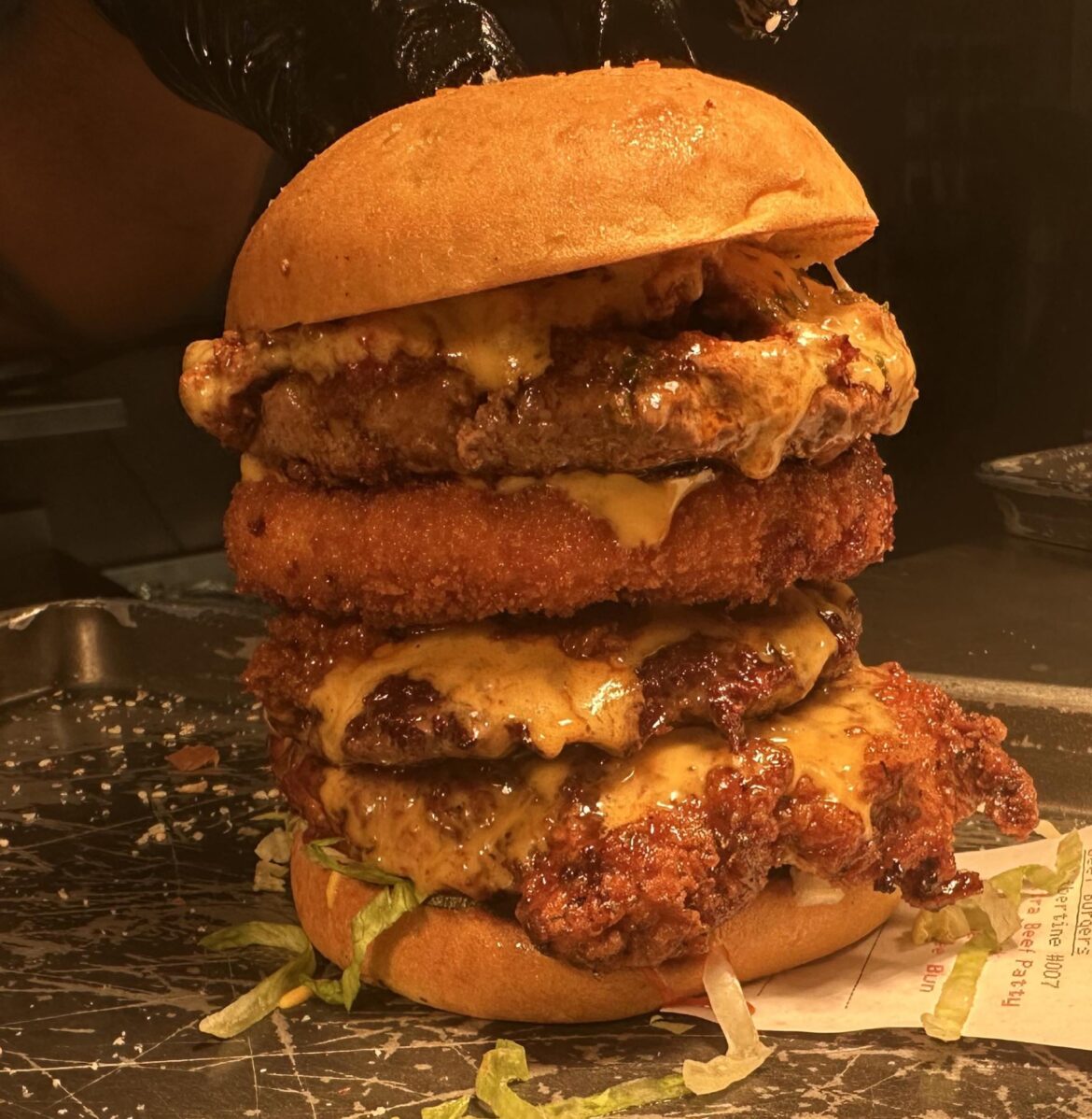 Customer ordered our chilli cheese burger with extra beef patty, mac and cheese patty and fried chicken breast on a gluten free bun. £24 burger
