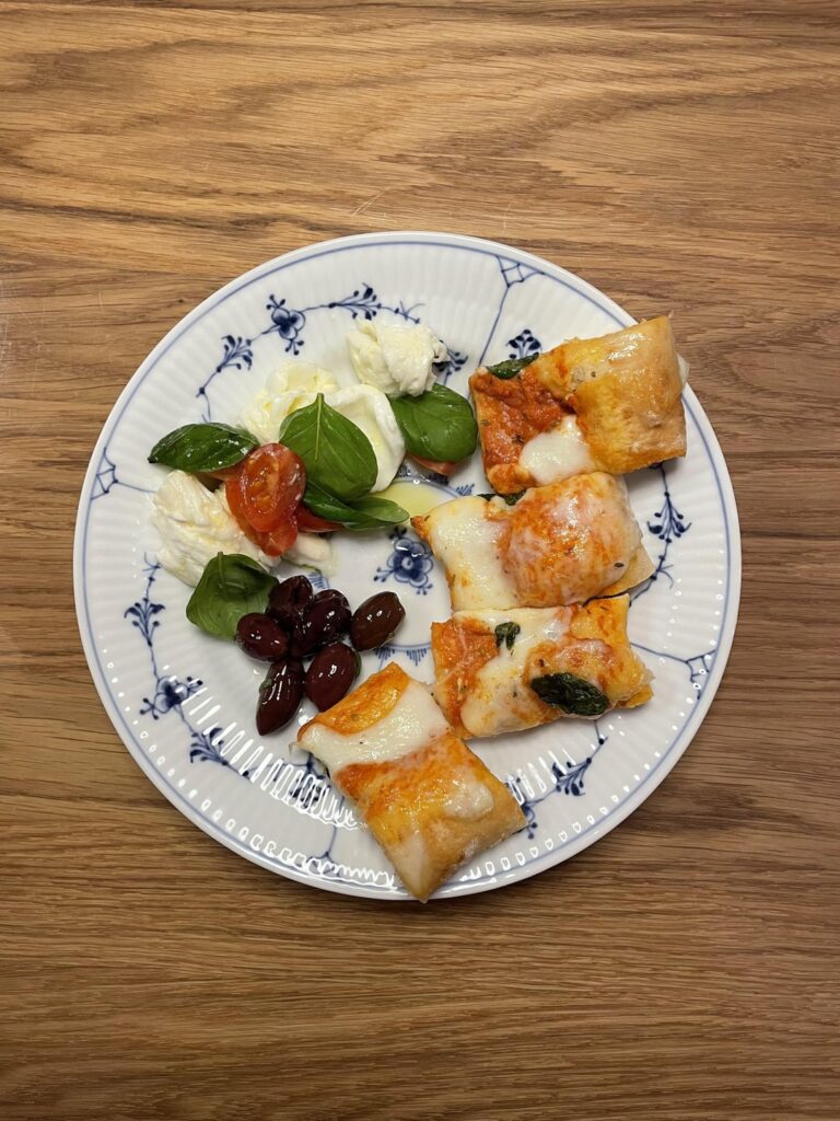 Focaccia pizza hack with a side of Caprese and olives