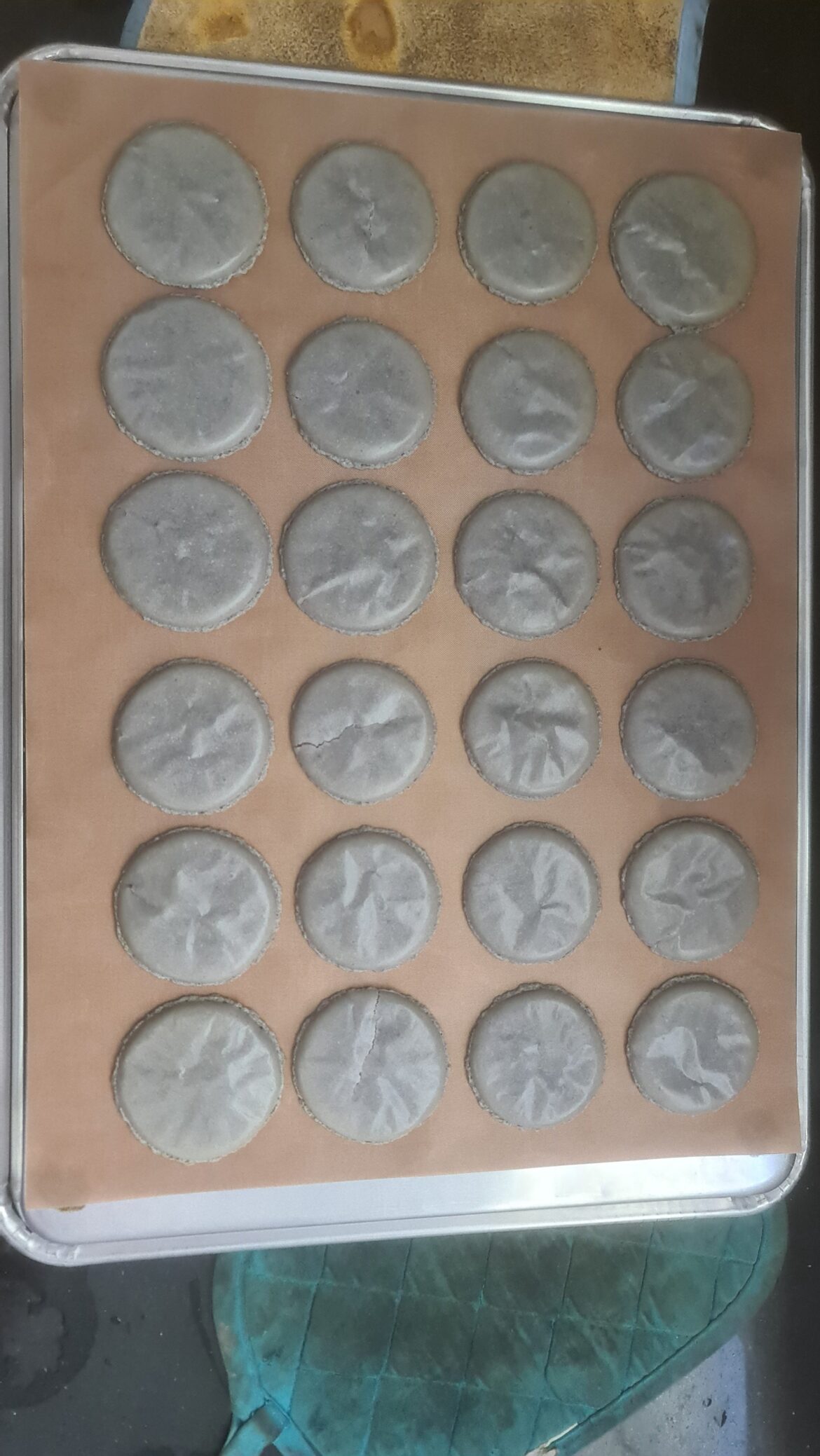 Macarons always wrinkled after the oven, and some stick to the teflon sheet.