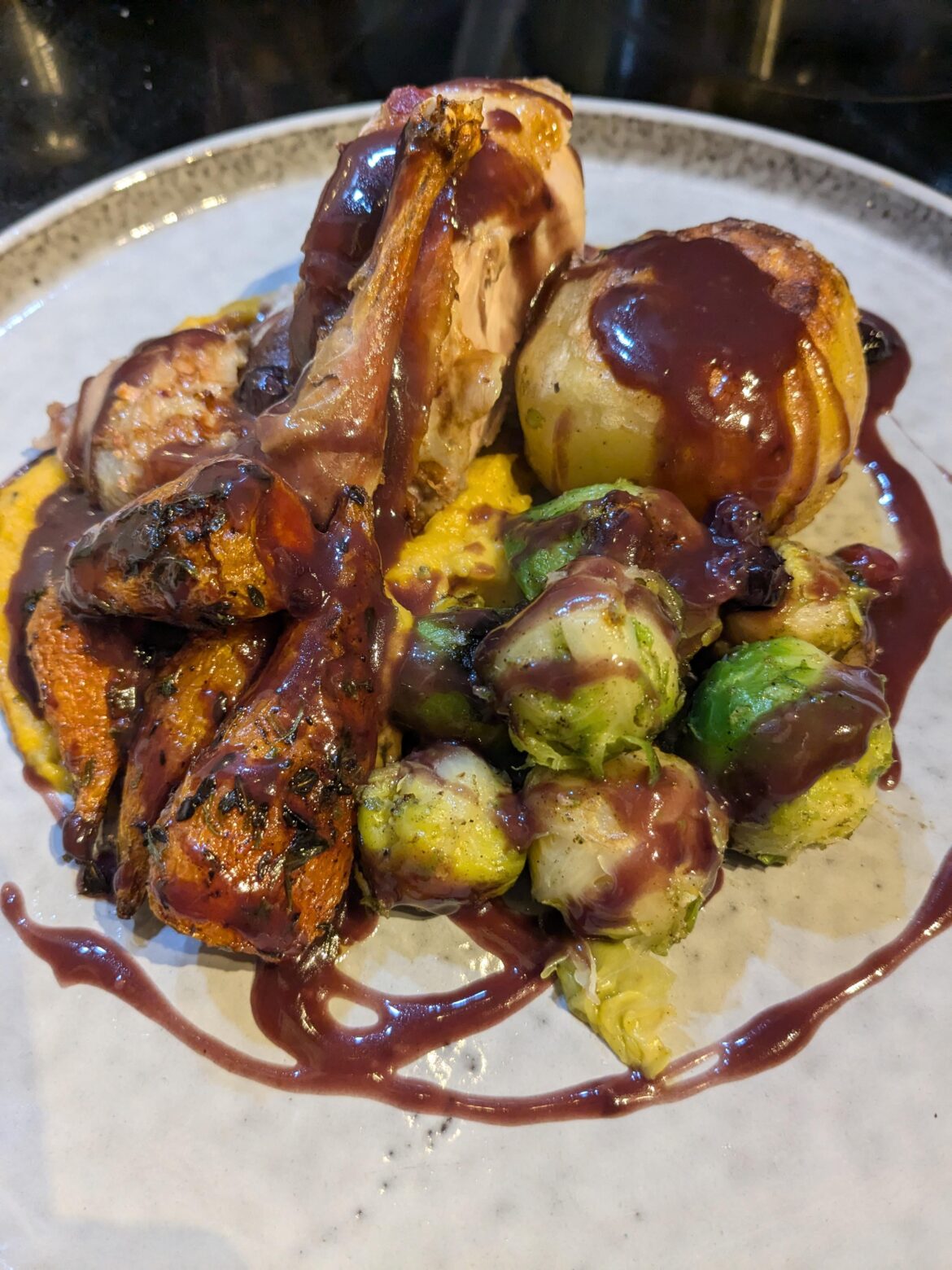 Roast partridge, fondant potato, anise roasted chantonnay carrots with tarragon, sauteed sprouts, butternut puree and a spiced port reduction with blueberries.