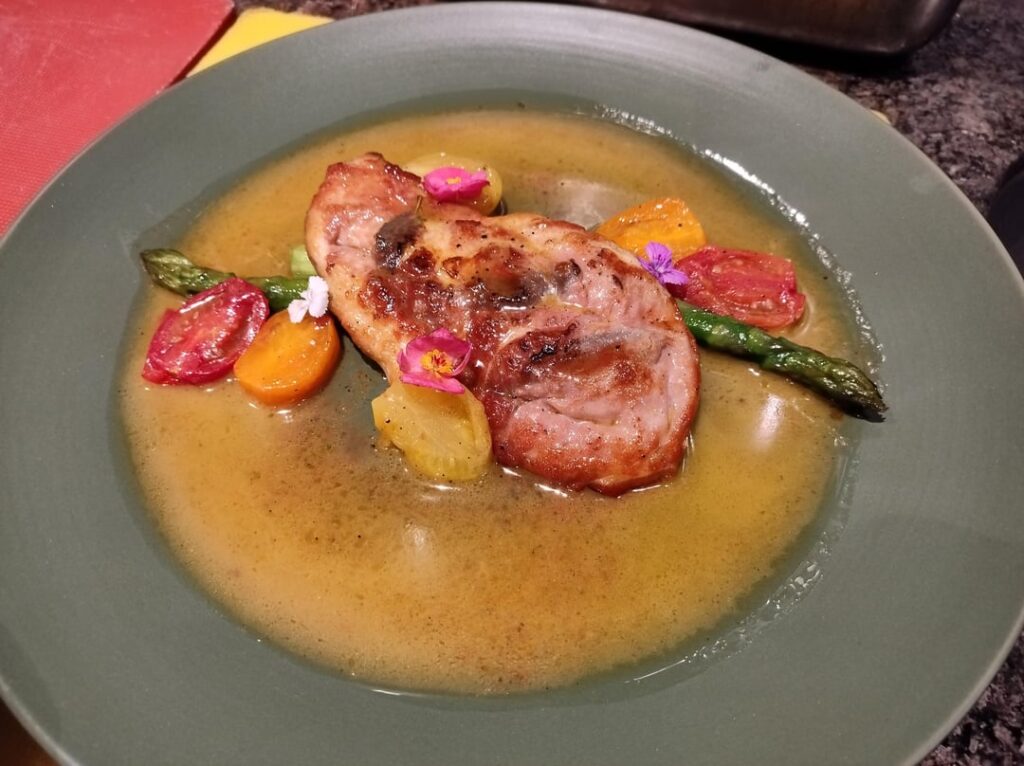 Chicken saltimbocca with butter poached asparagus served with cherry tomato and wine sauce