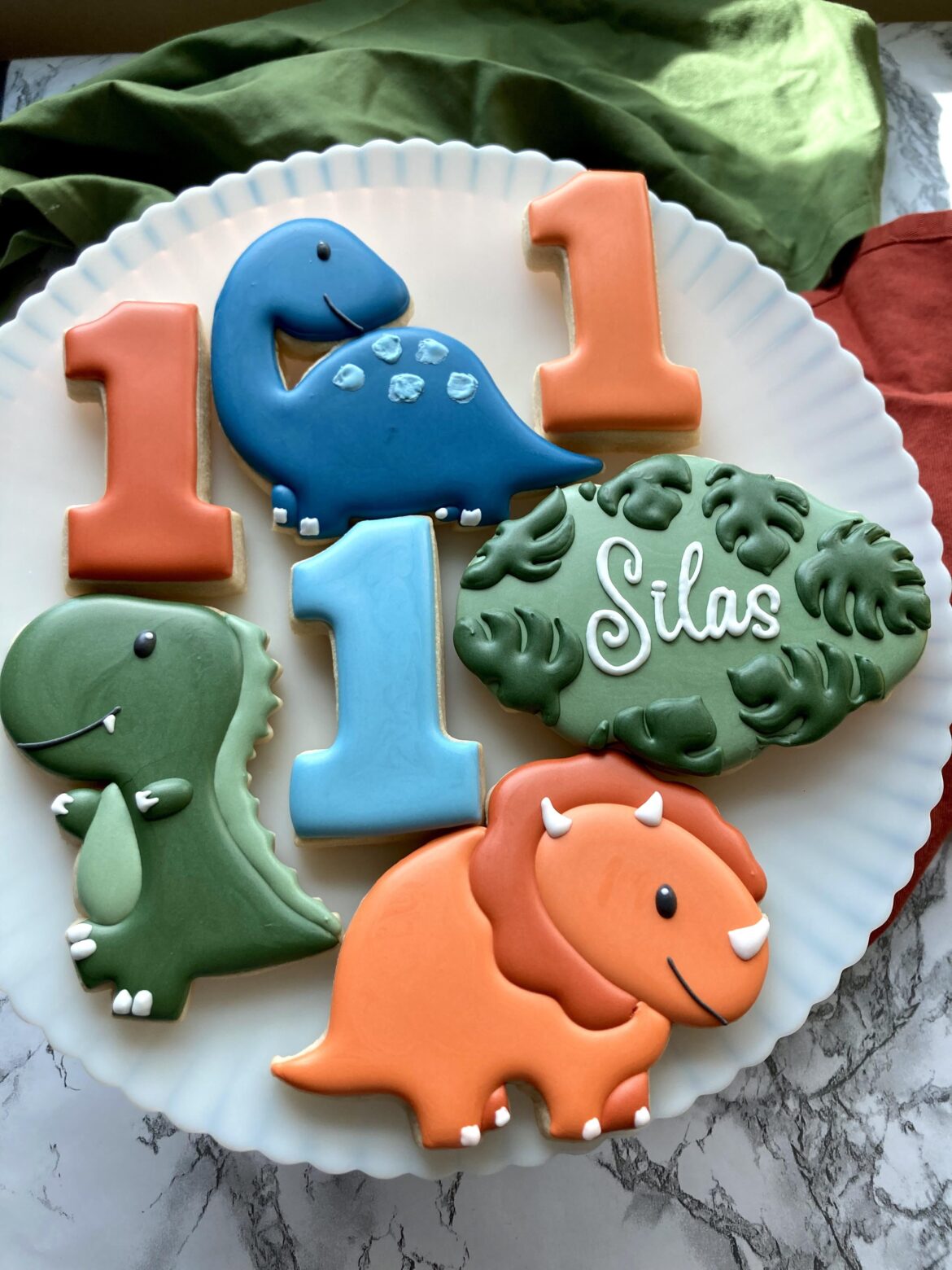 I had a shipment of cookie cutters get delayed in the mail, so I had to cut the dinosaur shapes out with a knife 🤯 I have a projector so it wasn’t difficult, just so tedious. Luckily I didn’t need many of them.