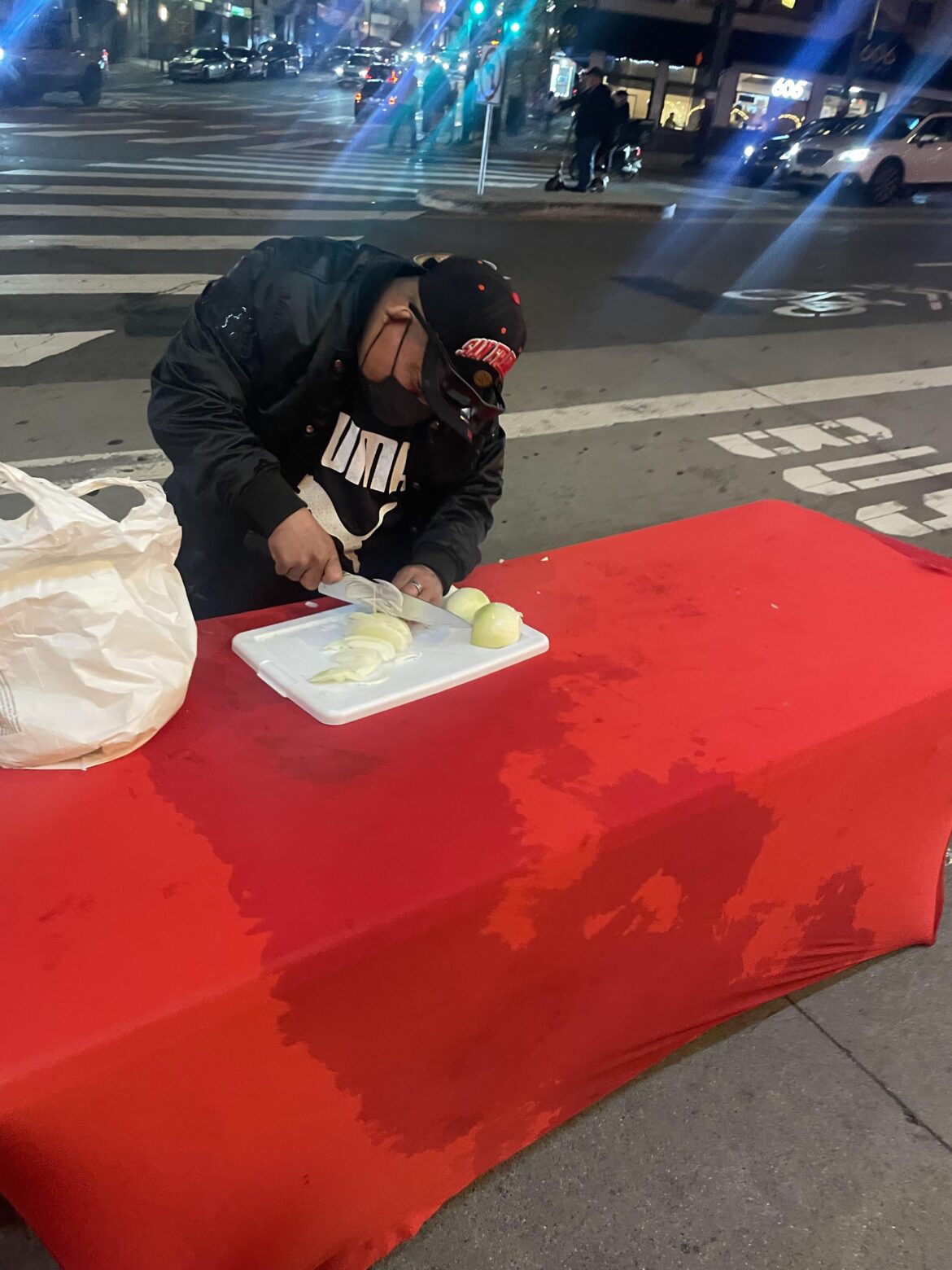 Man cutting onions in downtown San Francisco
