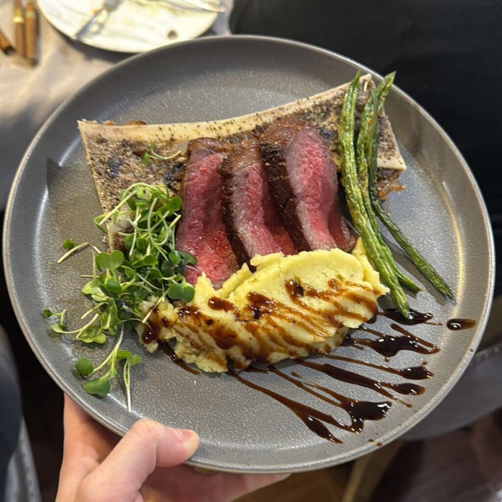 Roasted bone marrow with Rosmary salt and pepper reverse seared smoked ribeye with garlic mashed potatoes balsamic glaze asparagus and microgreens