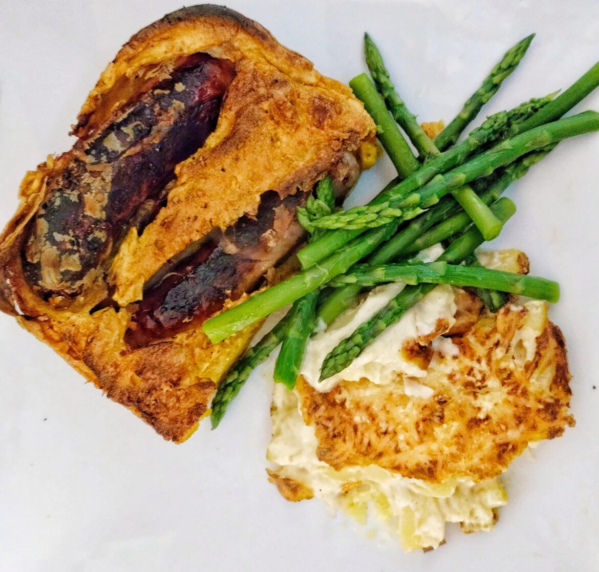 Toad in the hole, potato Dauphinous, and asparagus spears