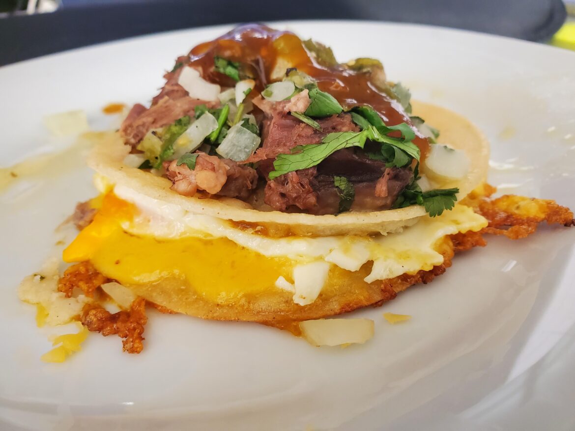 Lengua taco with melted cheese and fried egg between the tortillas. Last Dab Pepper X and T Bell hot sauce.