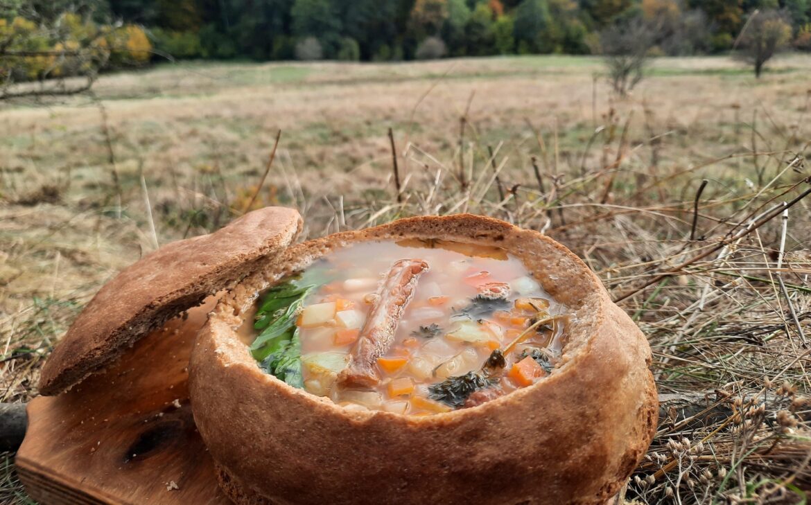 Bean soup with smoked meat, served in bread