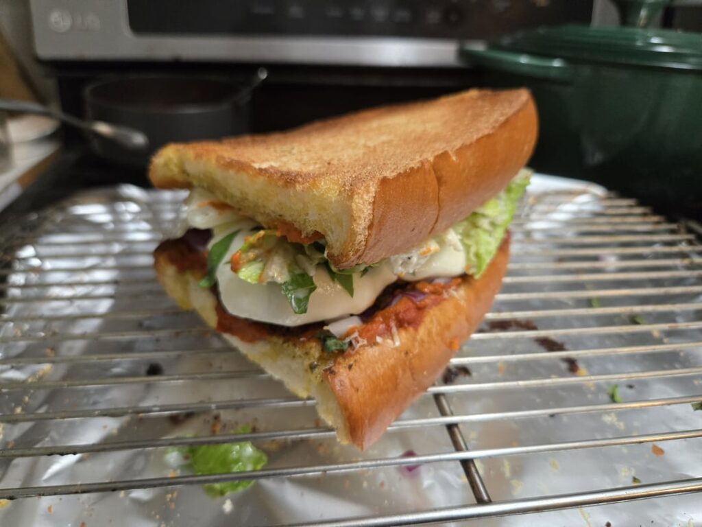 Chicken parm on garlic bread with caesar salad