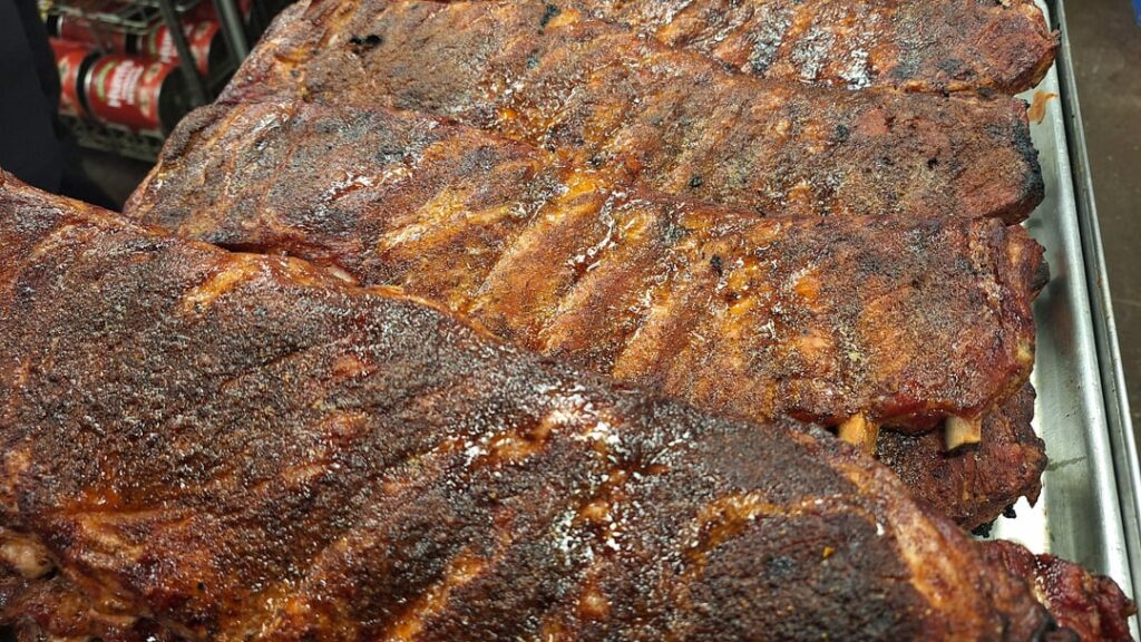 Dry rubbed st Louis cut spare ribs coming out of the pit. About three and a half hours at 235F. Alder wood smoke.