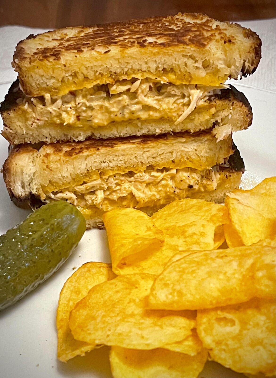Tuna Melt on homemade brioche with cheddar sour cream chips and a pickle