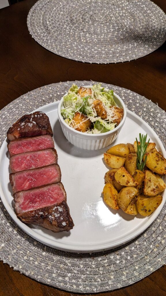 Prime Strip Rare with Cesar Salad and Roasted Potatoes