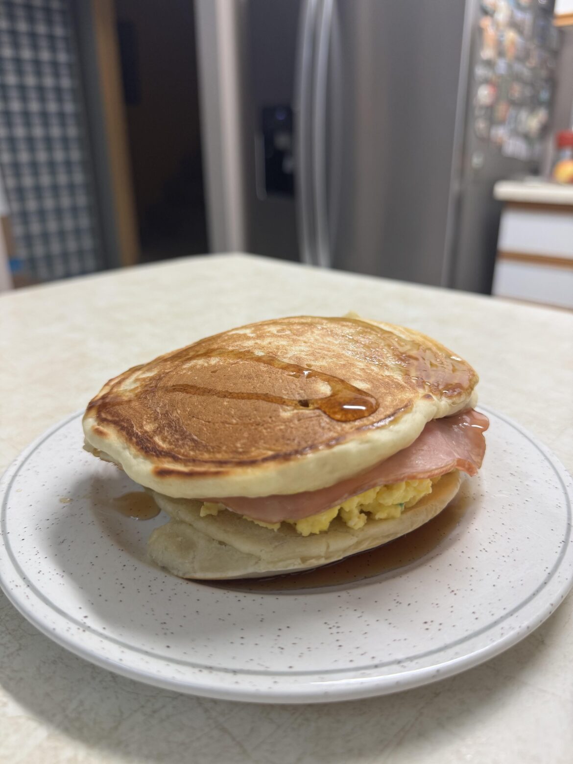 Pancake breakfast sandwich with maple syrup