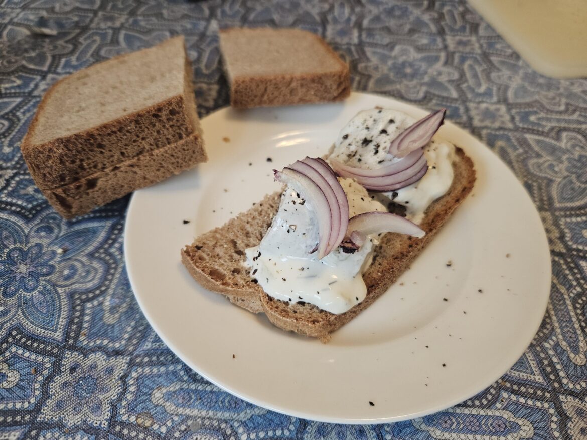 An open sandwich with herring in cream