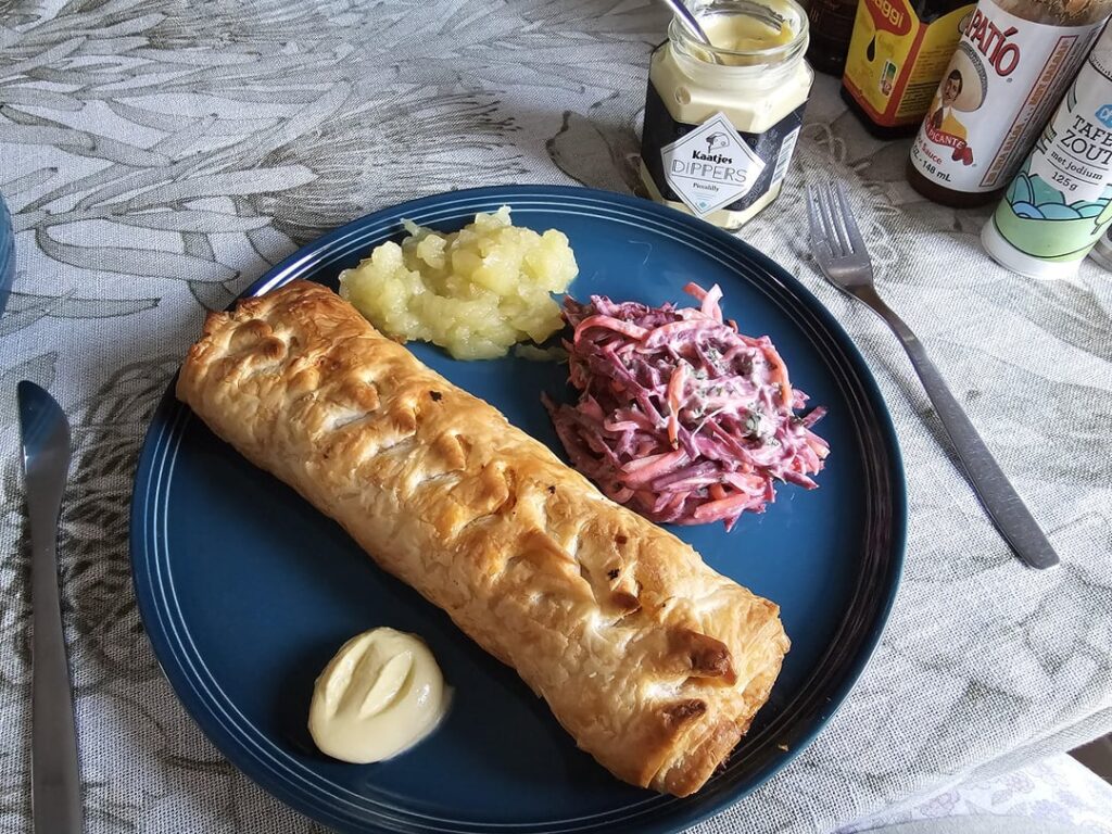 Sausage roll with apple sauce and carrot slaw