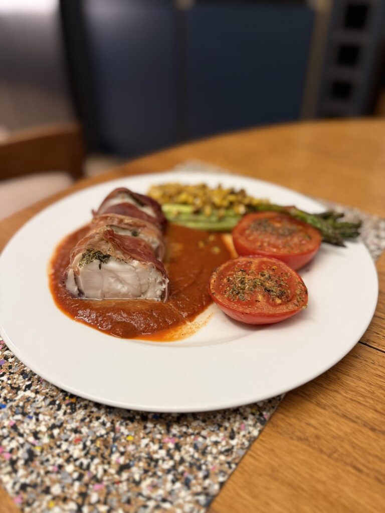 Parma ham wrapped monkfish with Romesco sauce, charred corn and asparagus Parma ham wrapped monkfish with Romesco sauce, charred corn and asparagus