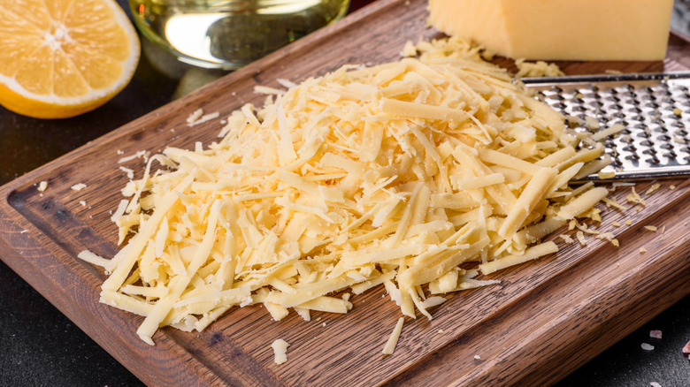 Grated cheese on wooden board