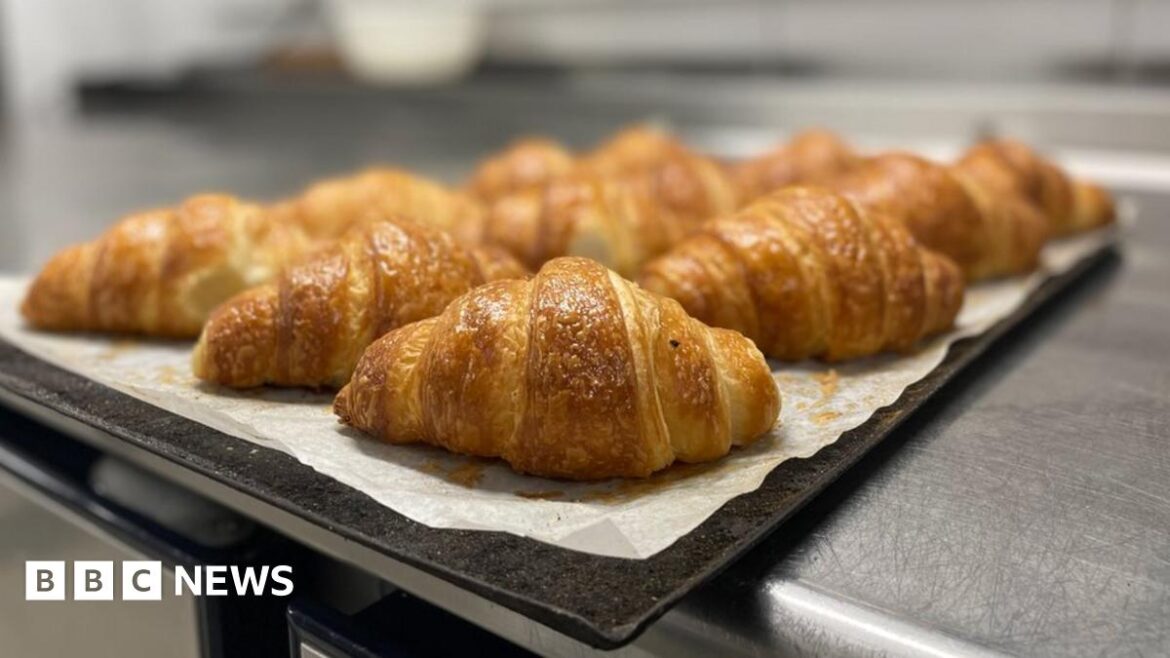 Croissants sit on a tray ready for sale at a bakery in Paris