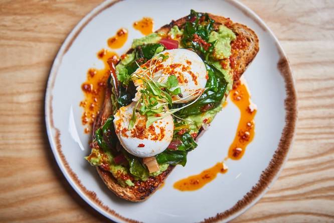 Avocado toast wtith eggs, herbs and chilli oil