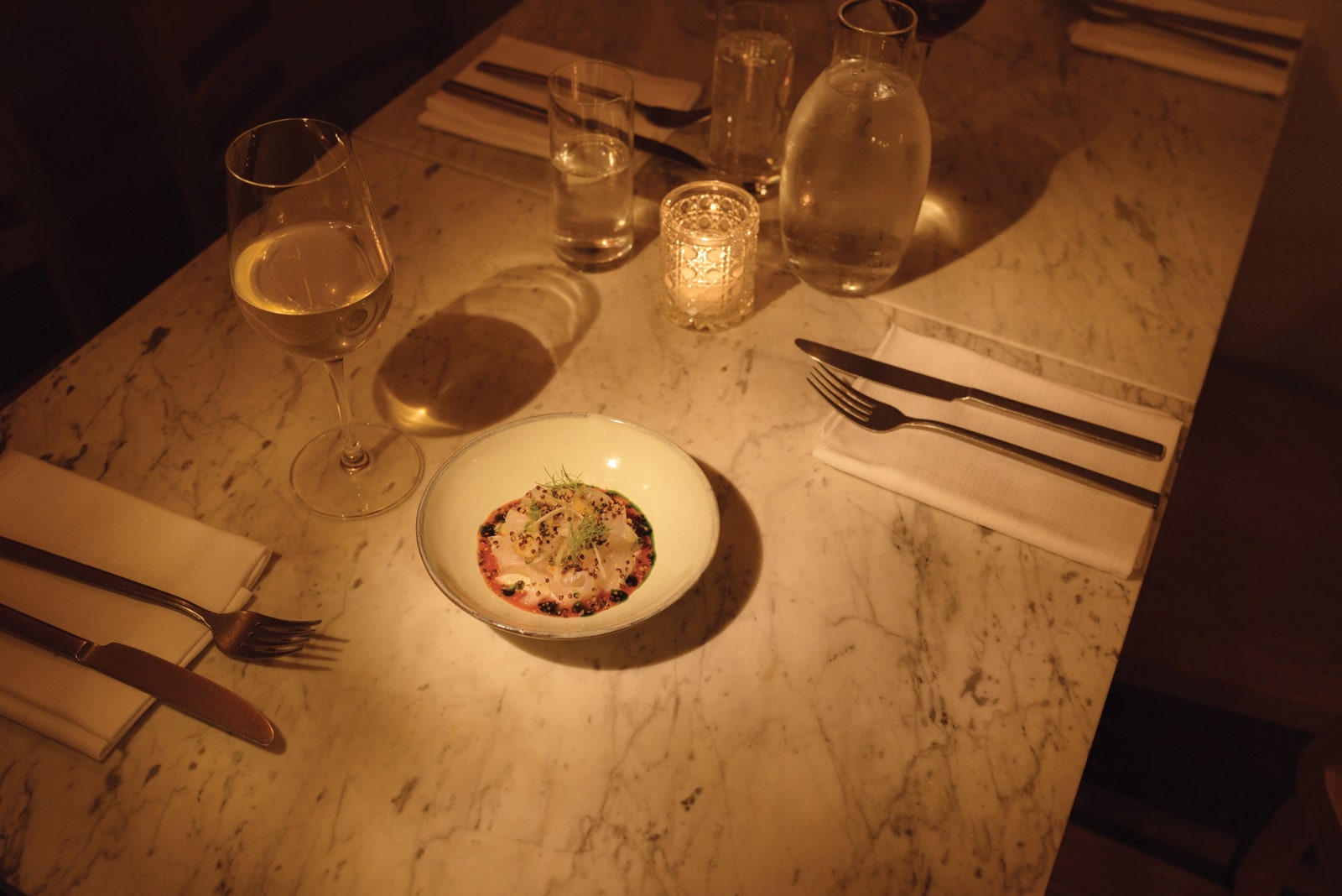 Image may contain Furniture Table Dining Table Glass Cutlery and Fork