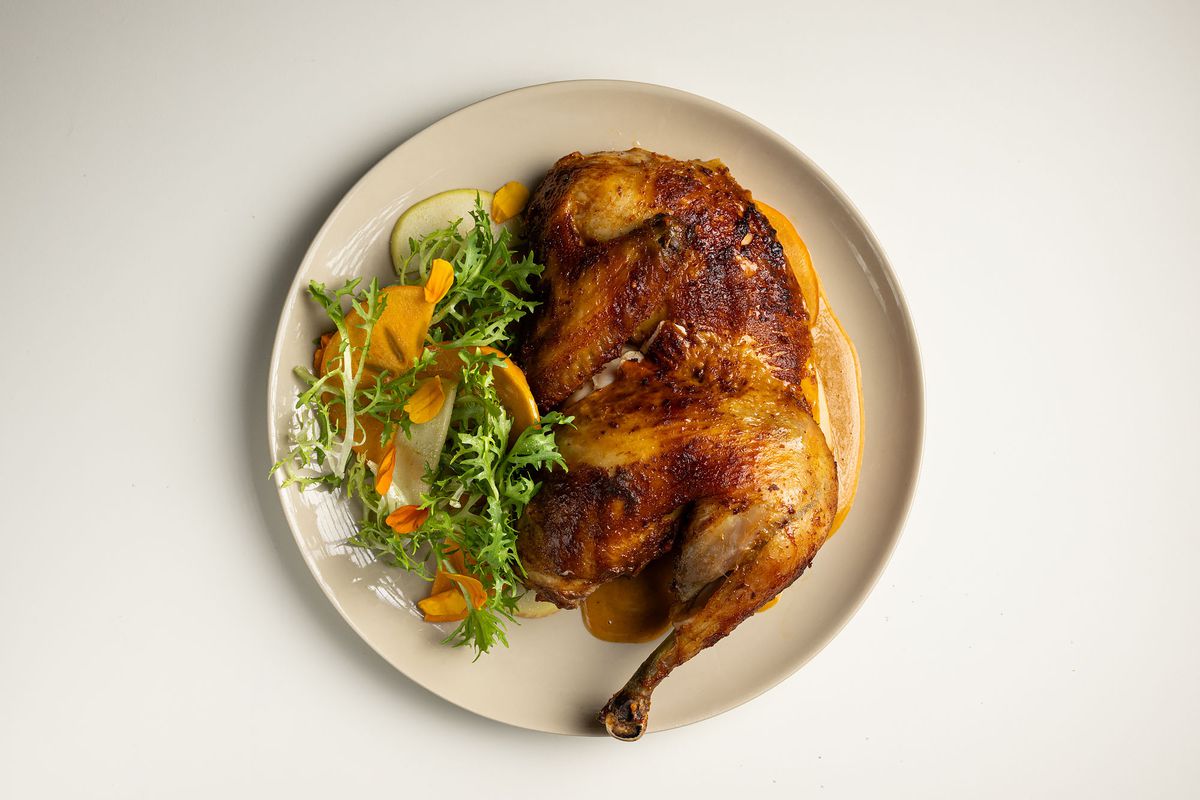 Rotisserie chicken, persimmon Béarnaise, apple salad at Bar Etoile.