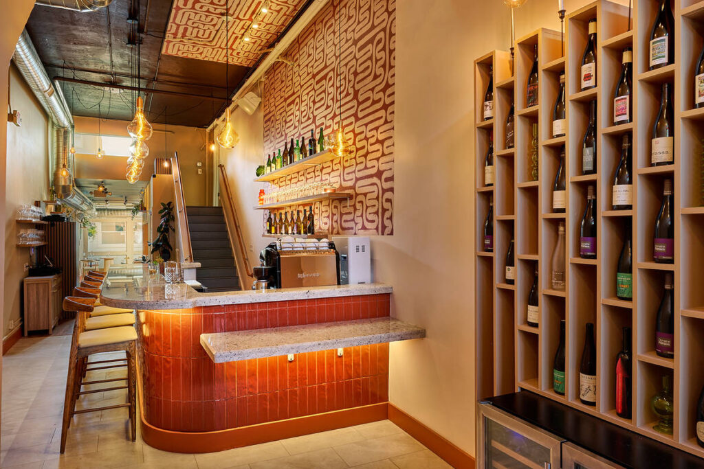 a bright room with a bar and stools