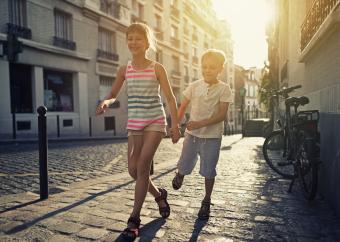 Children running down a French street