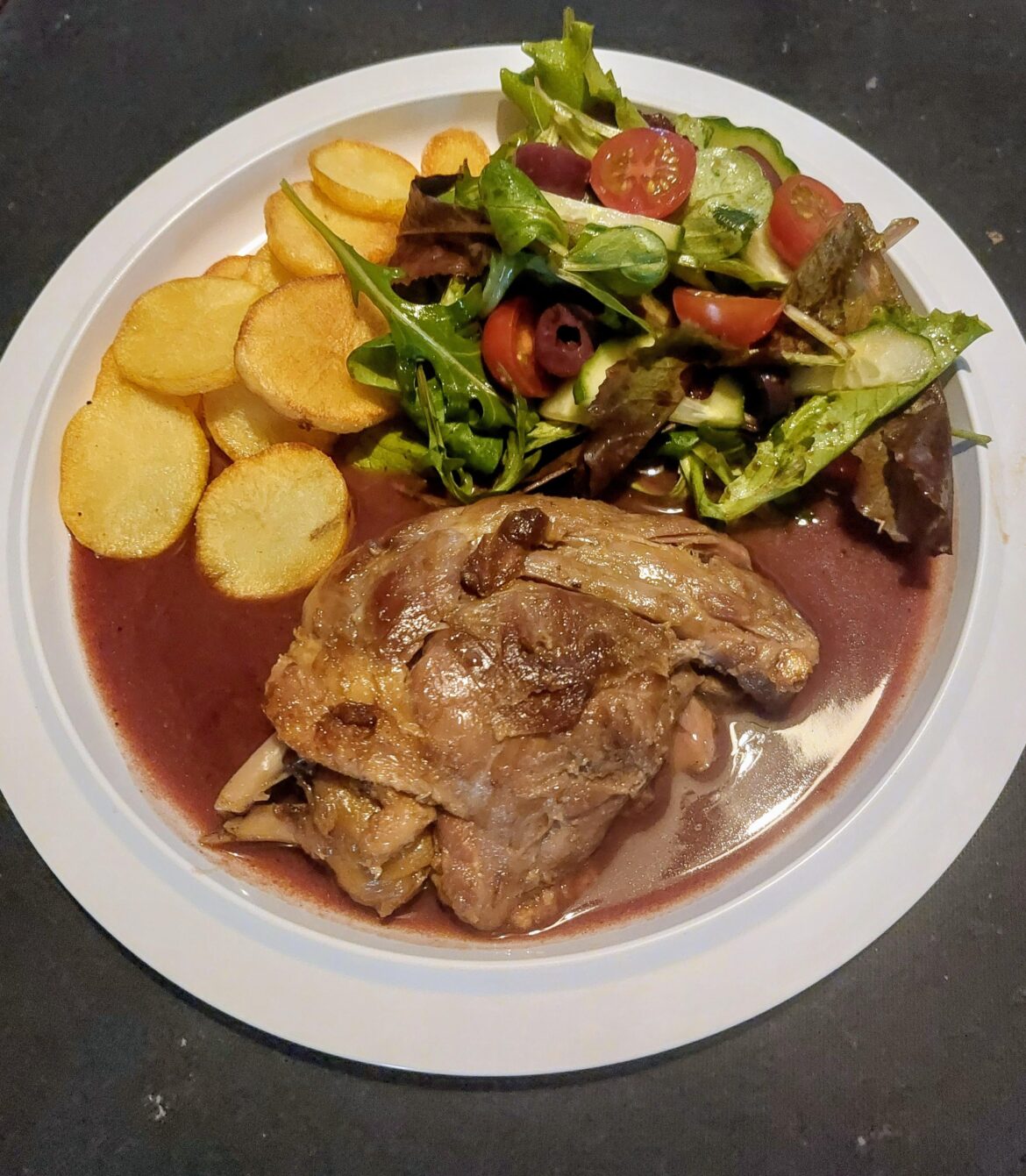 Confit duck with port-orange sauce, fried potatoes and salad