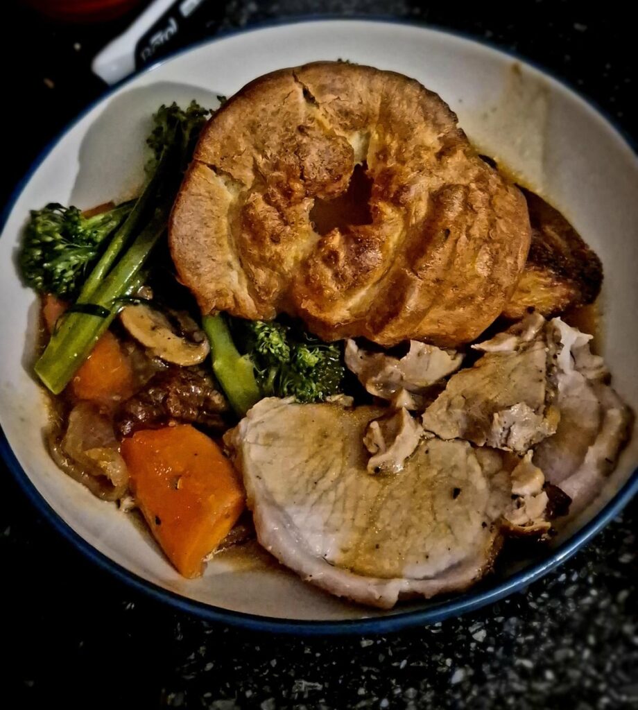 Roast pork loin, potatoes are hiding but are in next picture.