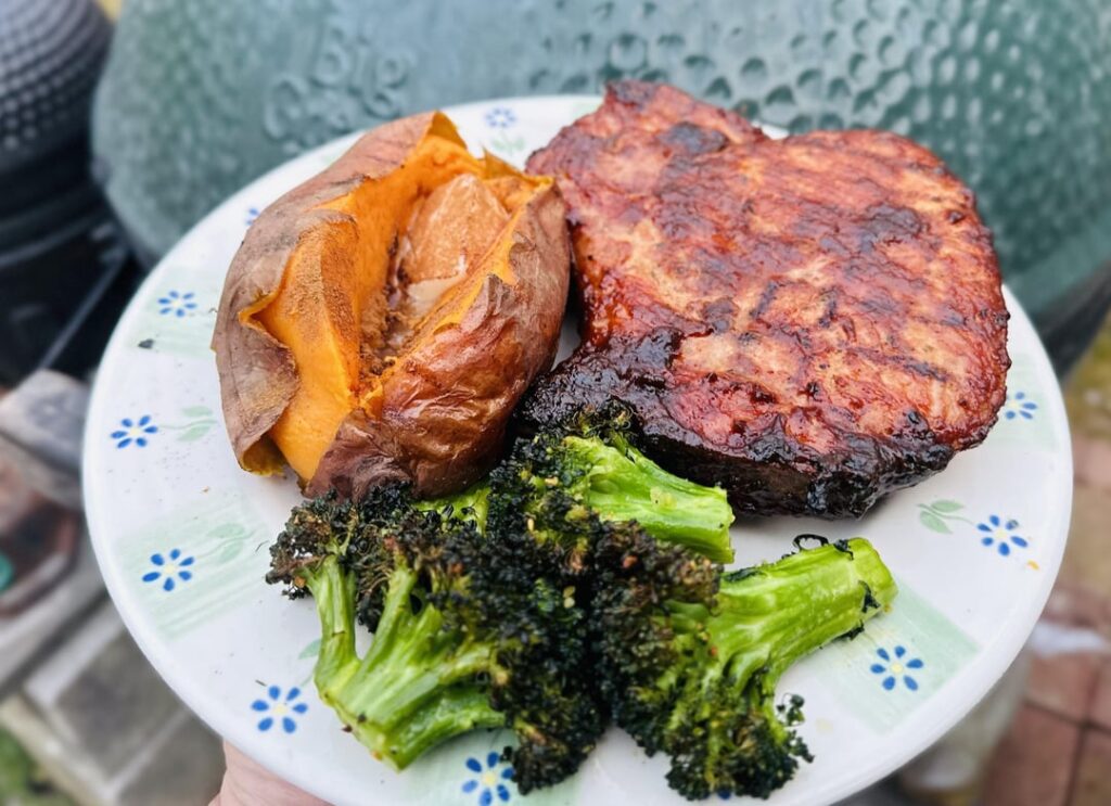Bbq Bone-In Pork Chops with Roasted Broccoli and Baked Sweet Potato.