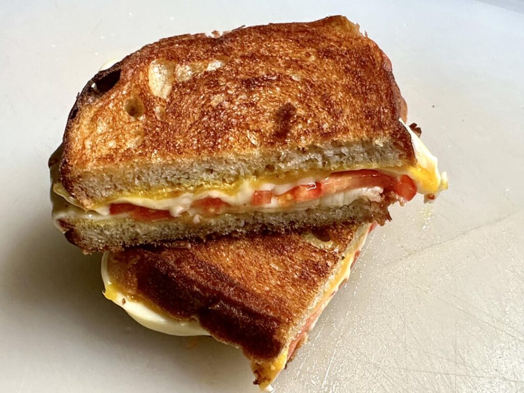 Simple tomato and cheese melt on homemade bread
