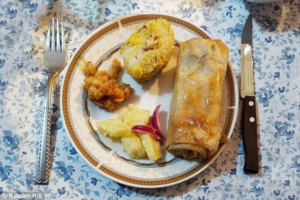 We have an array of dishes on our table: fish, baked beans and potato salad with onions