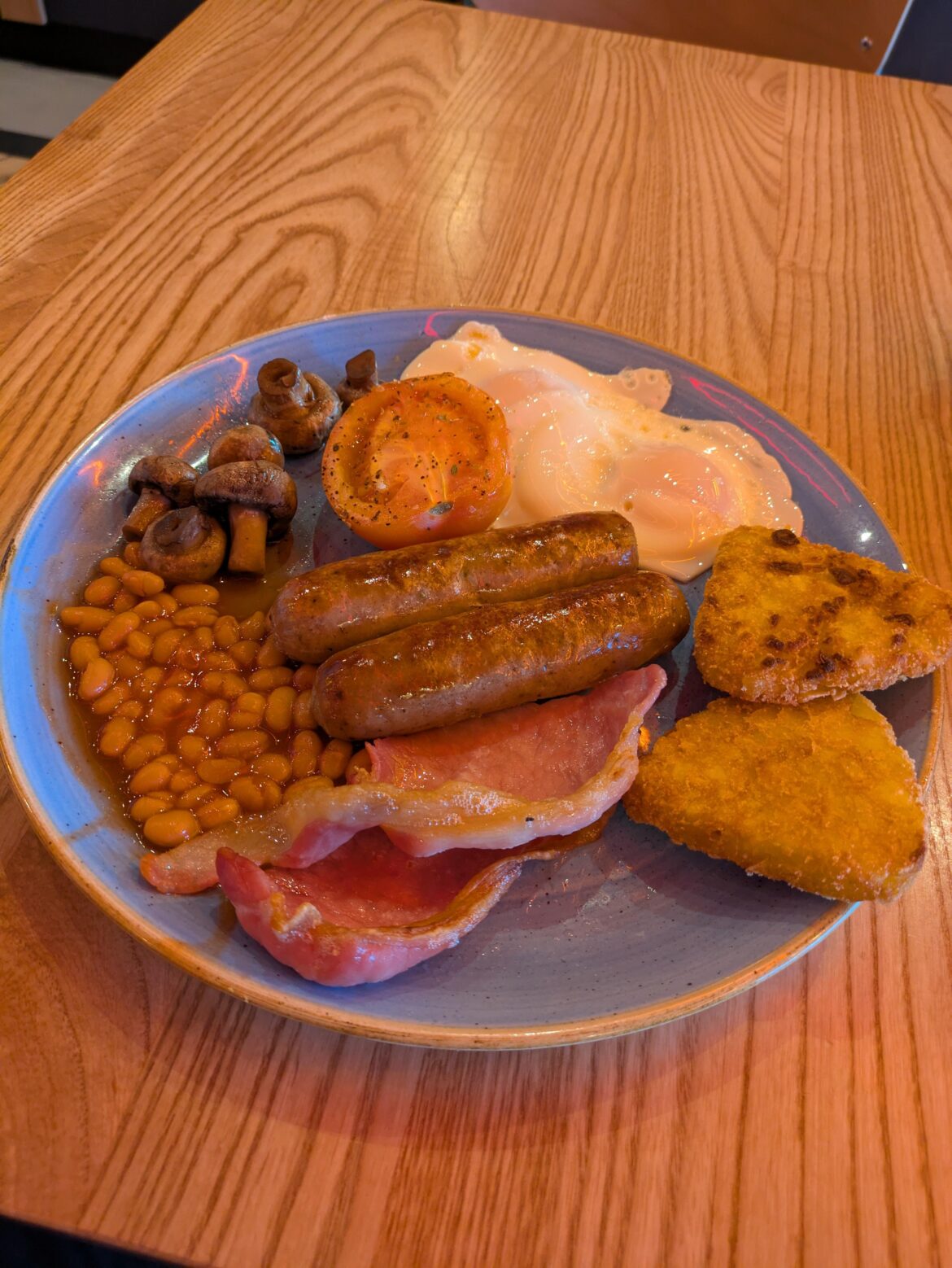 Manchester Airport terminal 2. Sat in the cafe and cannot see the name anywhere, but it's very orange in here. £17