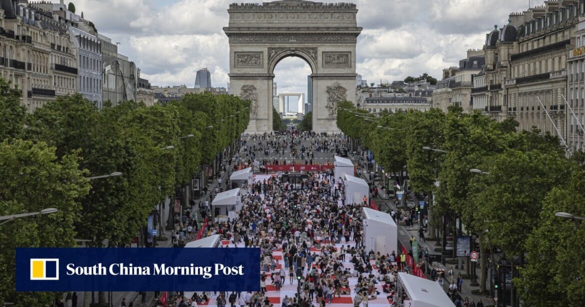 Paris’ traffic-clogged Champs-Elysees turned into a mass picnic blanket for an unusual meal