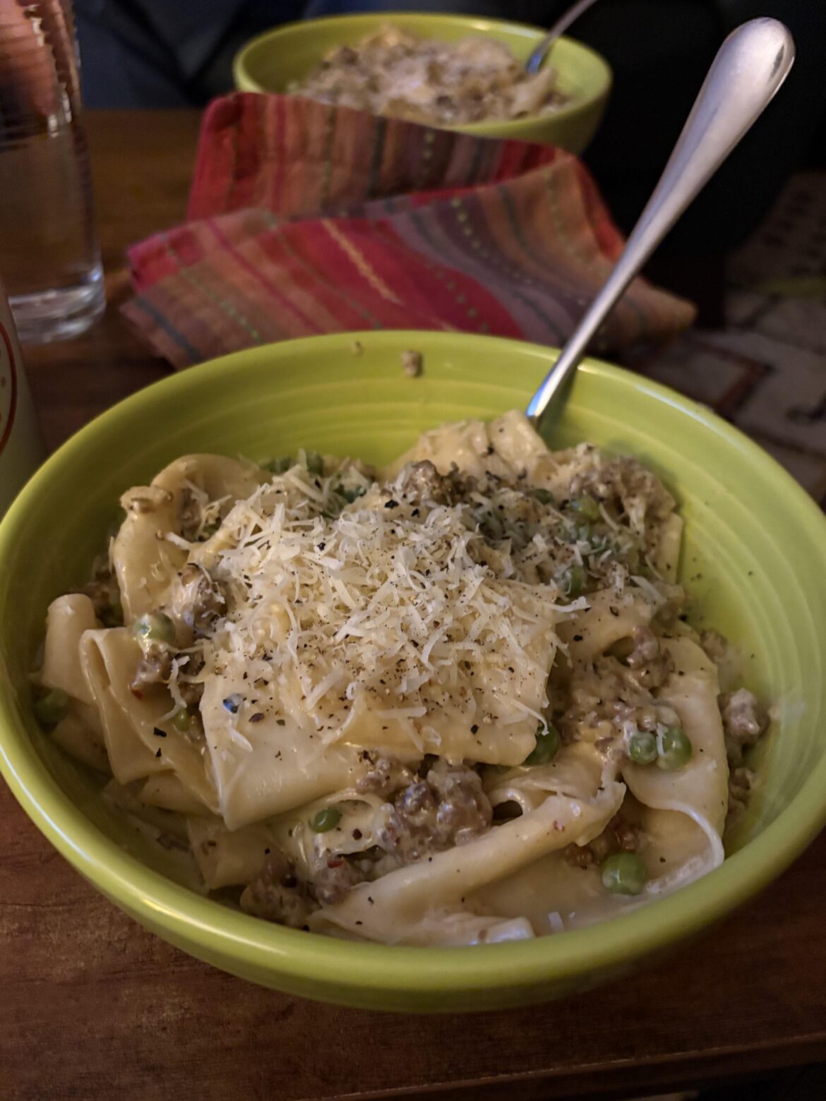 homemade pappardelle with sausage, fennel, peas, and garlic lemon cream sauce