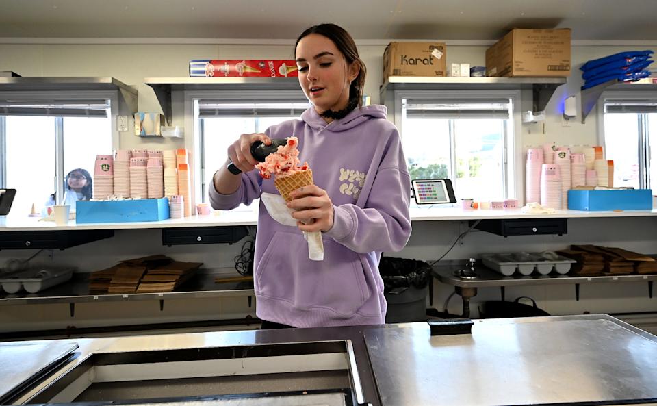 Breen Nichols, 15, of Hopkinton makes a cherry vanilla cone while working at Uhlman's.