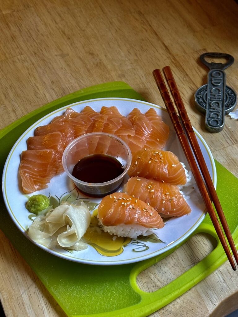 Some Sashimi I made for lunch. Delicious, just broke down a salmon for some more! And a couple Cali Rolls. Cheers! 🥂