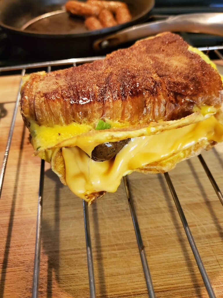 Made a breakfast lunch with what I had. Croissant dipped in egg stuffed with chicken breakfast sausage and American cheese.