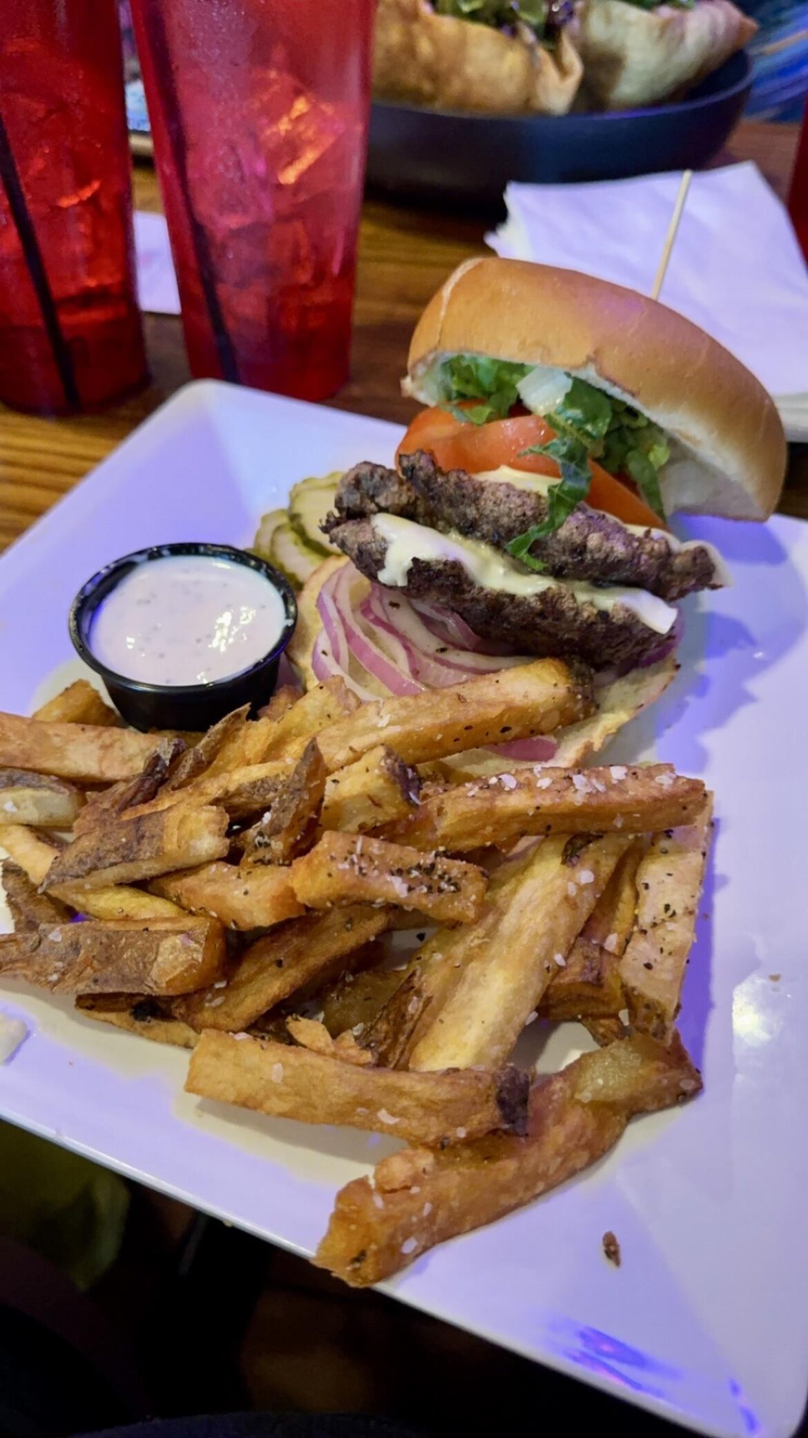 Cheese burger with white American, lettuce, red onion, tomatoes, pickles, seasoned fries and ranch in Rehoboth Beach DE