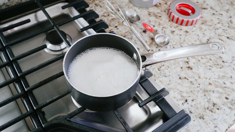 Pan of milk simmering on a stove