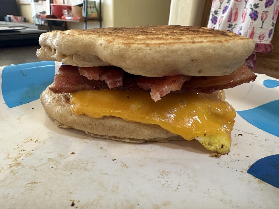 Breakfast yumminess. 3 strips bacon, fried hard egg, cheddar slice, syrup injected flapjacks.