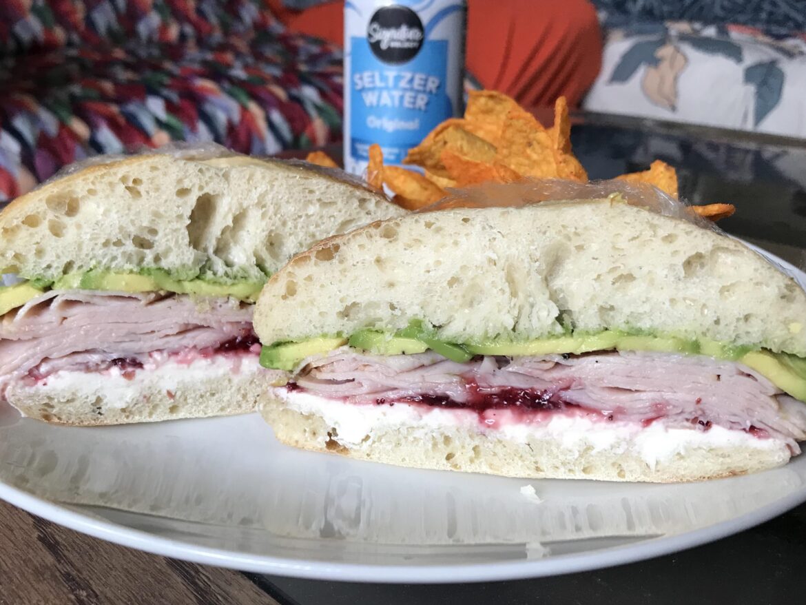 Turkey, avocado, cream cheese, and ligonberry jam on a ciabatta